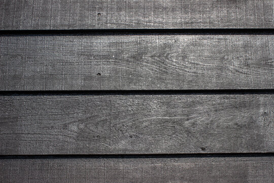 Black painted old wooden wall made out of planks