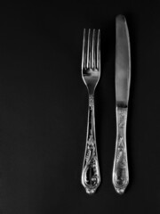 fork and knife with copy space on black background