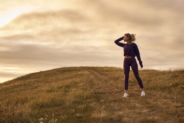 Fit woman resting after jogging in nature