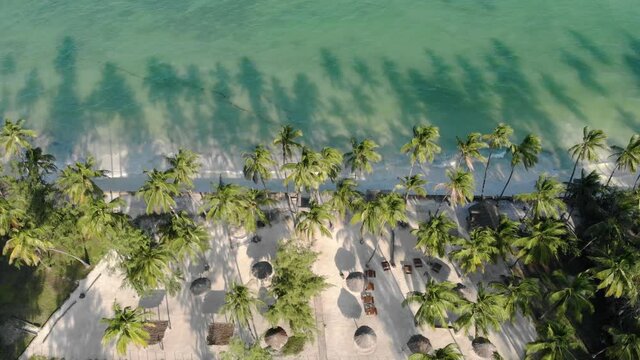 aerial view of thatched roof of luxury ocean view resort at the beautiful white sand ocean coast in paje at zanzibar island tanzania