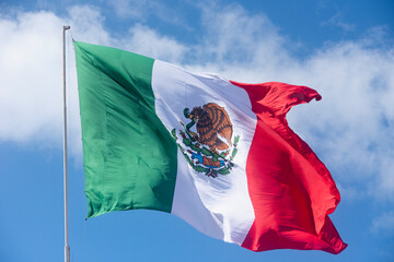 National flag of Mexico against the blue sky