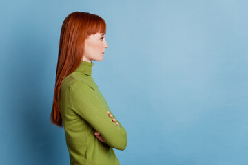 Profile side photo of serious woman cross arms isolated over blue background