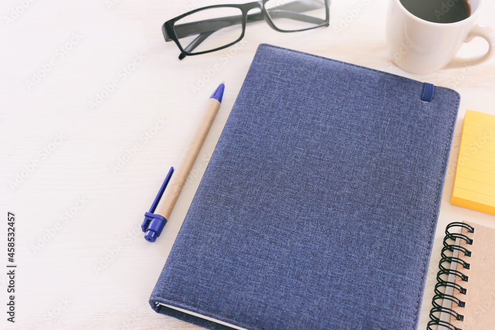 Fototapete top view image of open notebook with blank pages next to cup of coffee on wooden table. ready for ad