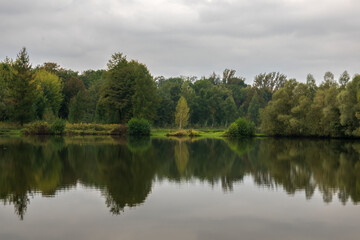 Rain clouds over ponds in early fall