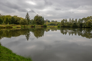 Rain clouds over ponds in early fall