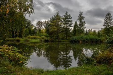 Rain clouds over ponds in early fall
