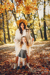 Cute and stylish family in a autumn park