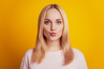 Portrait of charming adorable flirty lady send air kiss on yellow background