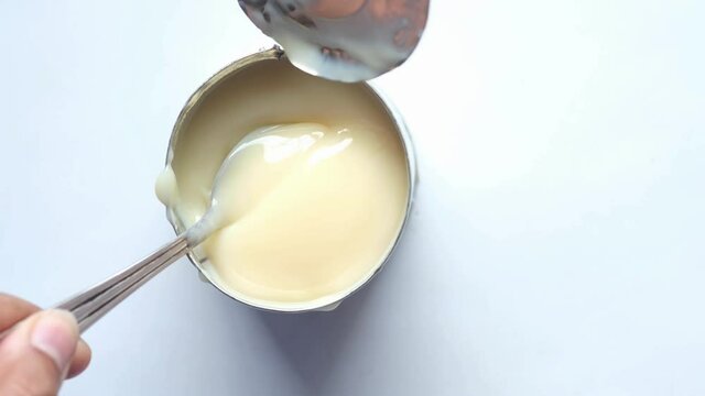 condensed milk in a bowl on a white background 