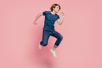Fototapeta na wymiar Profile portrait of funky sporty guy jump look empty space on pink background