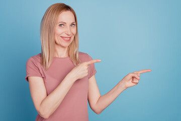 Photo of young woman happy positive smile indicate fingers empty space select suggest advertising...
