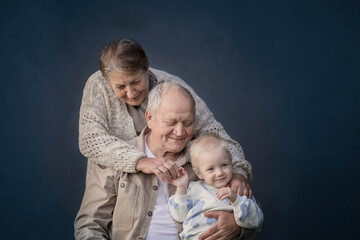 great grandmother and great grandfather with great grandson on blue background