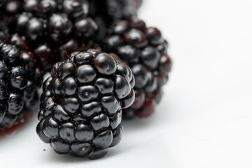 Ripe blackberries on a white plate. Useful forest fruits. Super food. Concept of healthy eating. top view. Close-up. Macro. Blackberry berries with water drops. Flat lay