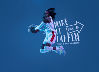 Artwork. Sportive african-american woman, female basketball player in motion and action in neon light on blue background with lettering, graphics