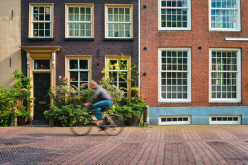 Bicycle rider cyclist man on bicycle very popular means of transoirt in Netherlands in street of Delft, Netherlands