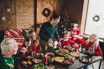 Portrait of nice cheerful family eating homemade dinner december eve noel custom at loft industrial home house indoors