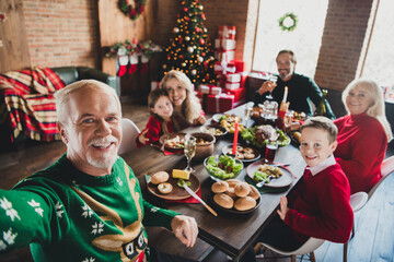 Photo of small childhood grandchildren grandparents pensioner retired friends noel big dinner table selfie xmas indoors house