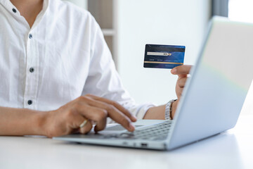 Man hands using smartphone and laptop computer for online shopping at home, Hand holding mobile phone with Payment Detail and credit card, online shopping concepts, Convenience online shopping