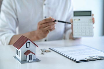 Real estate agents explain model homes to negotiate prices and documentation for customers who come...