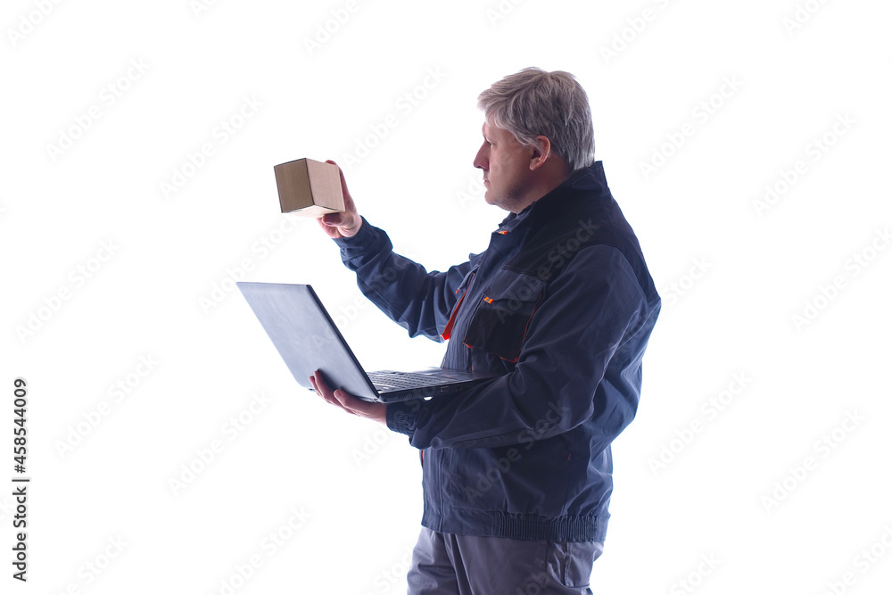 Poster storekeeper, courier at work. man checks the label of the box with the data in the laptop. a man in 