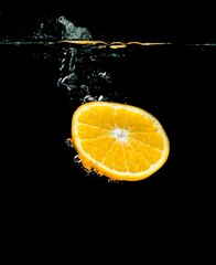 Orange Slice in Water on Black Background