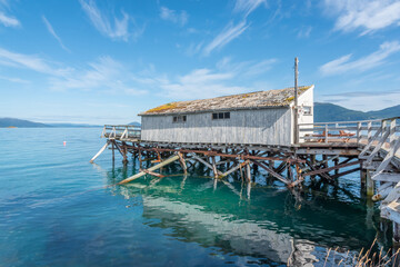 Old fishing shack and dock called Kvinnekaia in Senja Island in arctic Norway 