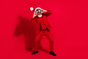 Obraz premium Photo of funky funny age gentleman wear new year costume headwear dancing disco ball close face isolated red color background