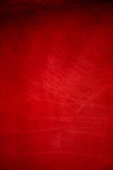 Dark red matte background of suede fabric, closeup. Velvet texture of seamless wine leather.