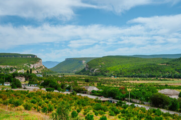 A village between two green hills, Crimea. Mountain landscape in summer