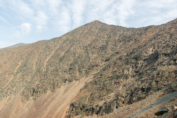 View of the mountain slopes against the backdrop of beautiful clouds