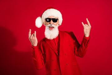 Photo of retired pensioner crazy happy old man wear sunglass rock signs sants claus isolated on red...