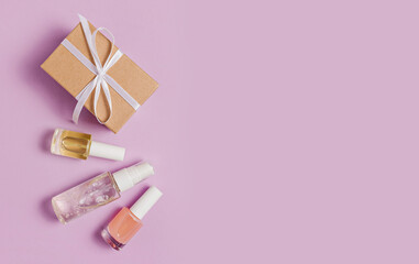 Organic cosmetics and gifts for the holiday. Flat lay, top view clear glass pump bottle, brush jar, moisturizing serum jar on a purple background. Natural cosmetics SPA