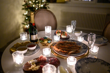 Calm image of interior modern home living room decorated christmas tree and gifts, sofa, table covered with blanket