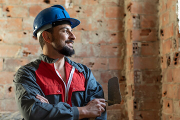 Bricklayer poses smiling while renovating a bathroom - obrazy, fototapety, plakaty