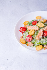 Caesar salad with red fish (salmon, trout), cherry tomatoes, croutons, parmesan cheese and romaine....