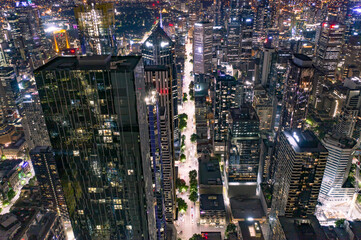 City Streets at Night Surrounded by High Rise Buildings and Skyscrapers