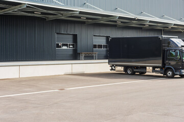 black truck at loading ramps of a warehouse