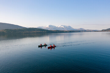 Canoeists on a Lake with Mountains in the Distance