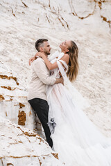 Fototapeta na wymiar Beautiful wedding couple bride and groom at wedding day outdoors at ocean beach. Happy marriage couple o