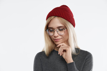 European girl in glasses thinking and looking down