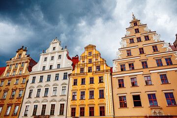 Fototapeta na wymiar Multicolored old buildings in Wroclaw, stormy clouds on background