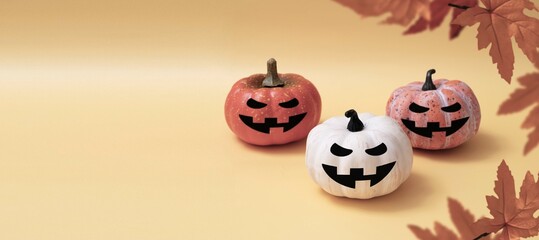 Three pumpkins with smiling halloween faces, autumn baner with copy space