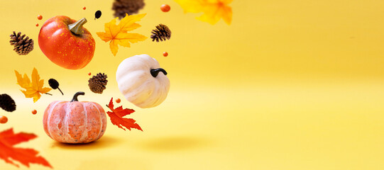 Three pumpkins on warm baner. Levitation autumn, halloween concept. Copy space.