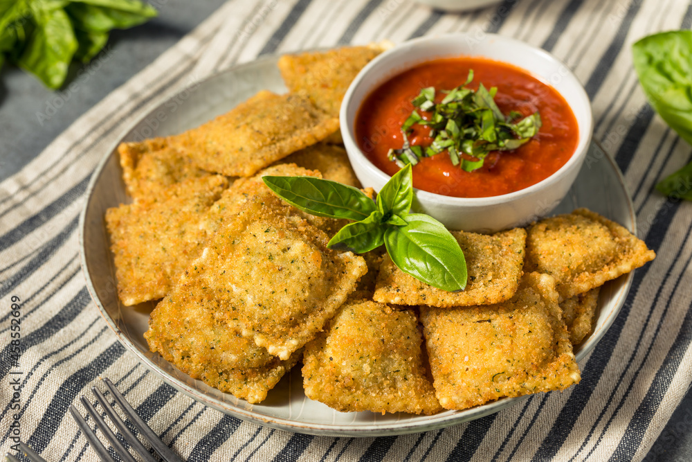 Poster homemade fried raviolis with basil