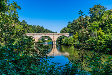 Fototapeta na wymiar A view down the River Wear towards the Prebends Bridge in Durham, UK in summertime