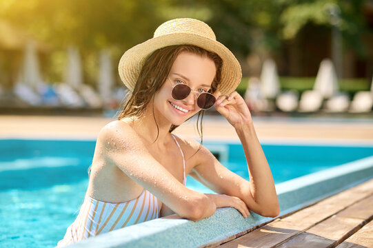 A picture of pretty young woman spending time in a pool
