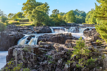 A long exposure view towards the Lower Force waterfall on the River Tees in summertime