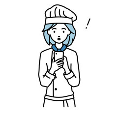 立ってスマートフォンを操作して何かに気づいて驚いた調理師の女性