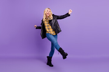 Full length body size view of pretty cheerful wavy-haired girl dancing having fun isolated over vivid violet purple color background