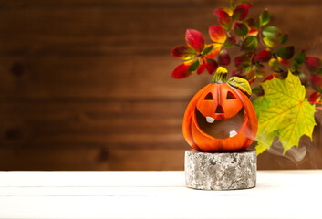Halloween party background. Podium or pedestal for products display and Funny Pumpkin. Halloween holiday decorations.